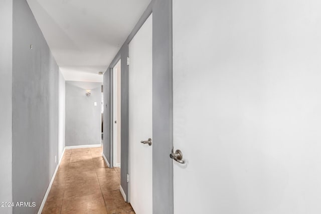 hallway featuring light tile patterned flooring