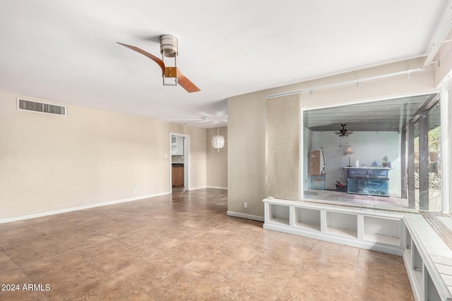 unfurnished living room with ceiling fan