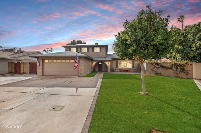 view of front of property featuring a yard and a garage