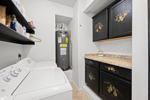 laundry room with water heater, washer and dryer, light tile patterned floors, and cabinets