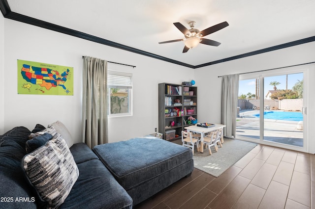 interior space featuring hardwood / wood-style flooring, a wealth of natural light, ornamental molding, and ceiling fan