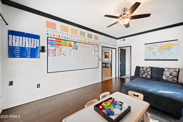 living room featuring ornamental molding and ceiling fan