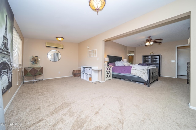 carpeted bedroom with a wall unit AC, a ceiling fan, and baseboards