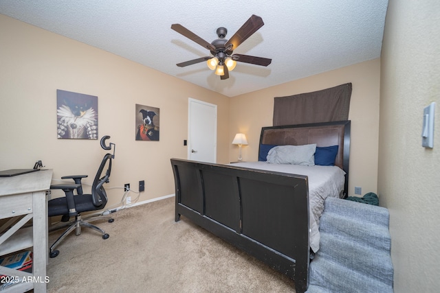 bedroom with a ceiling fan, light carpet, a textured ceiling, and baseboards