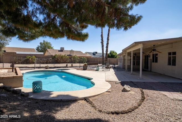 view of pool featuring a patio area, a fenced backyard, a fenced in pool, and a ceiling fan