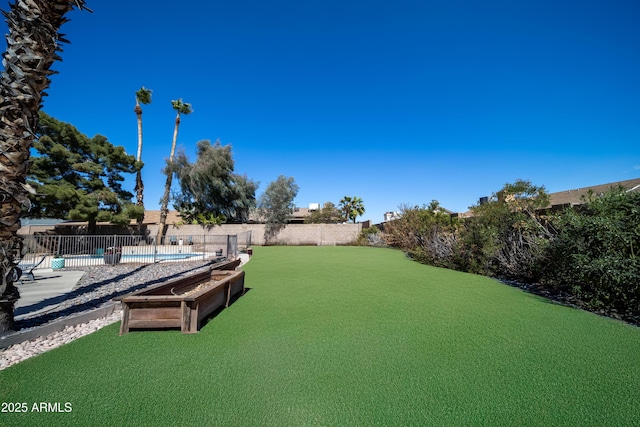 view of yard with a fenced in pool and fence