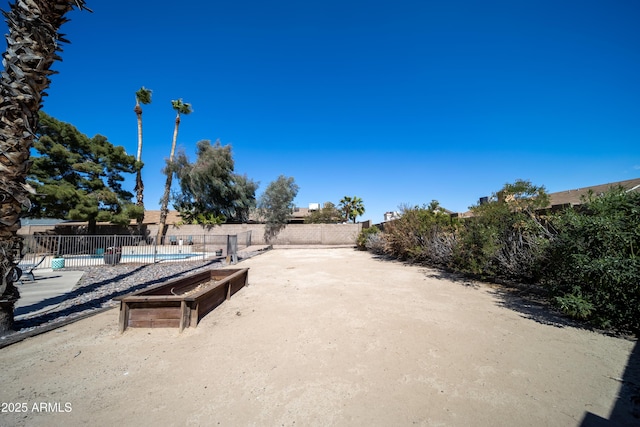 view of yard with fence and a fenced in pool