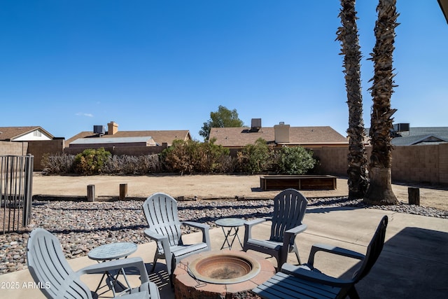 view of patio / terrace with an outdoor fire pit and fence