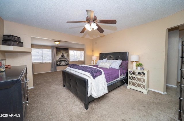 bedroom with ceiling fan, a textured ceiling, baseboards, and carpet flooring