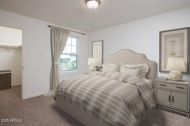 carpeted bedroom featuring a spacious closet, a closet, and baseboards