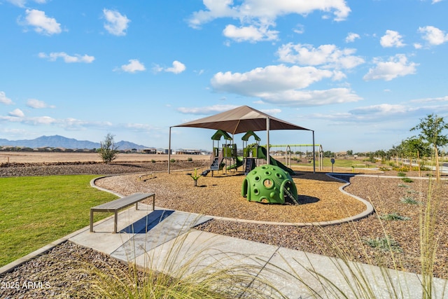 community playground featuring a lawn and a mountain view