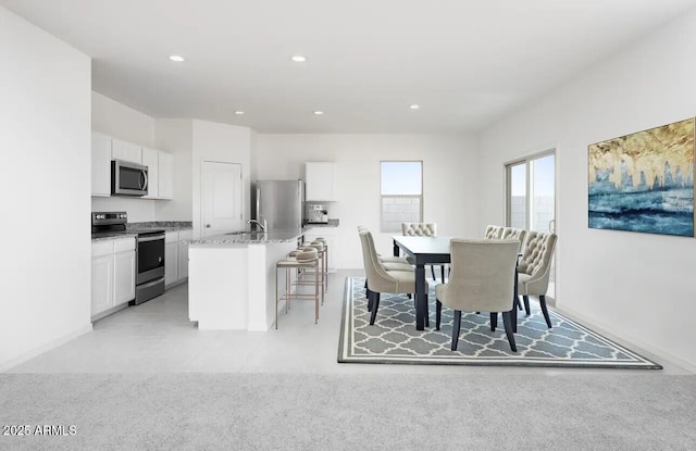 dining space featuring recessed lighting