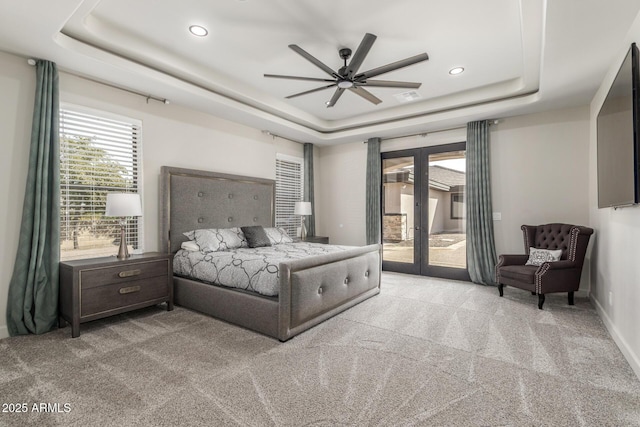 bedroom with visible vents, access to exterior, a tray ceiling, carpet flooring, and french doors