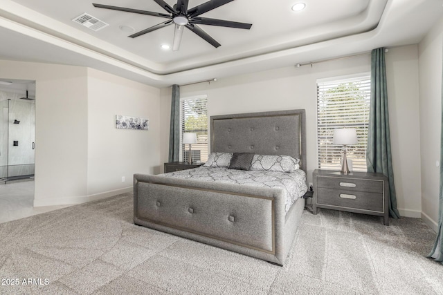 carpeted bedroom featuring baseboards, a raised ceiling, visible vents, and recessed lighting