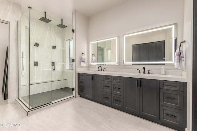 bathroom with double vanity, a stall shower, and a sink