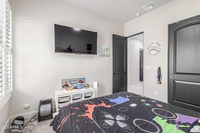 carpeted bedroom with visible vents and baseboards