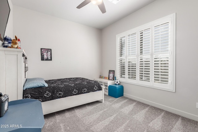 bedroom with ceiling fan, baseboards, and carpet flooring