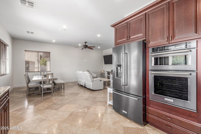 kitchen featuring appliances with stainless steel finishes, visible vents, and baseboards