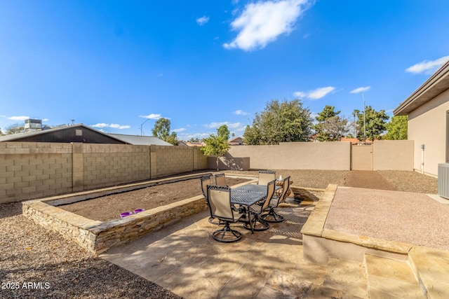 view of patio featuring a fenced backyard and outdoor dining area