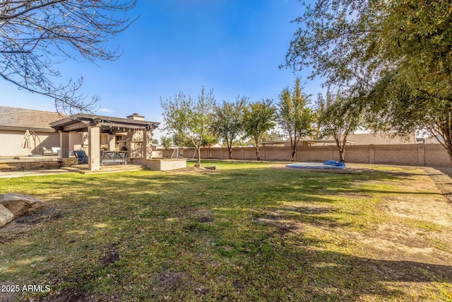 view of yard featuring a fenced backyard, a patio, and a pergola