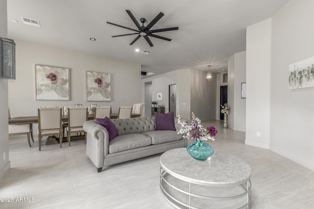 living area with ceiling fan, recessed lighting, visible vents, and baseboards