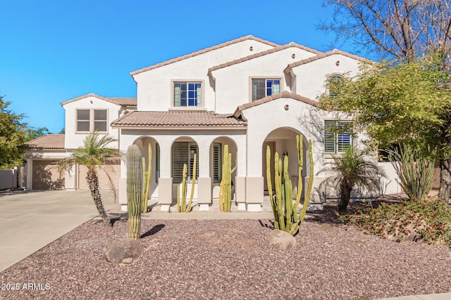 mediterranean / spanish-style house with a porch and a garage