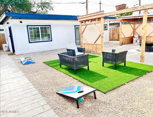 rear view of property with a lawn and a patio area