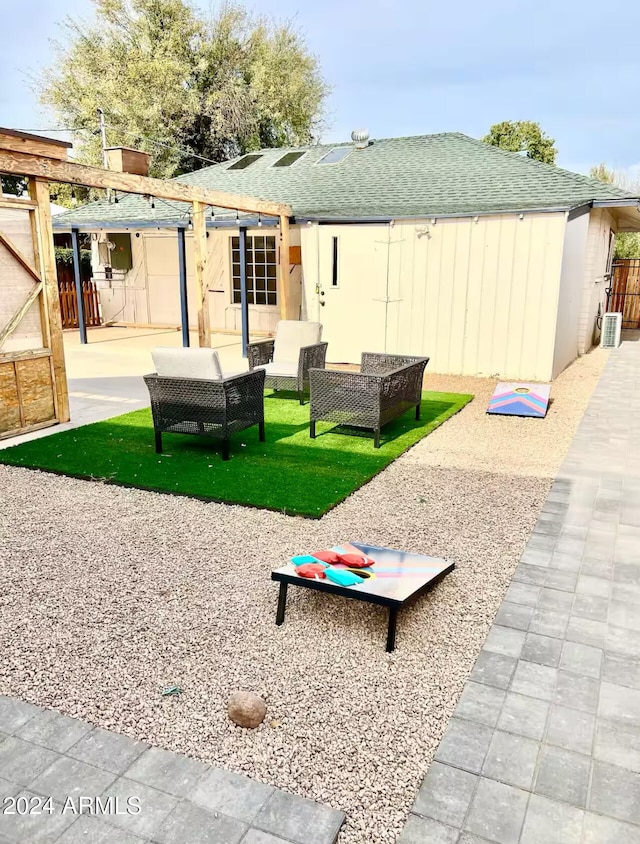 view of property's community with an outdoor living space, a patio area, and a yard