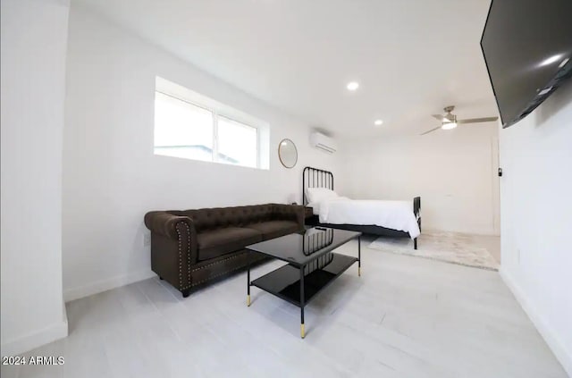 bedroom featuring a wall mounted air conditioner and ceiling fan