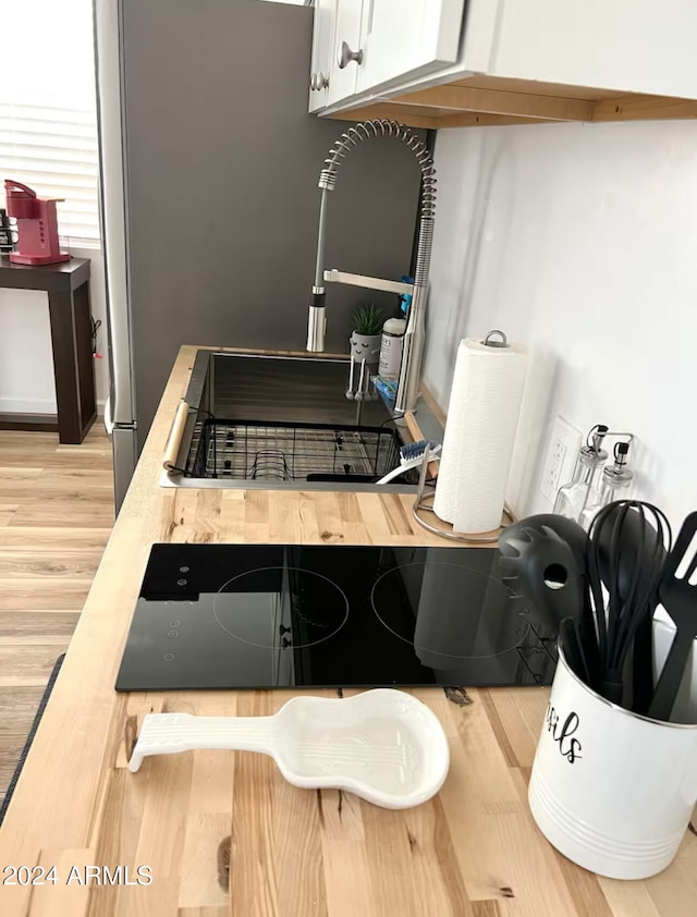 interior space featuring light hardwood / wood-style flooring and white cabinets