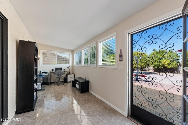 tiled entryway with lofted ceiling