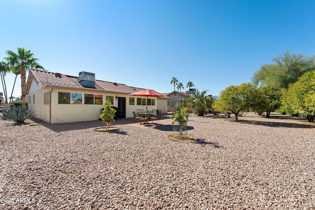 rear view of property with central AC and a patio area