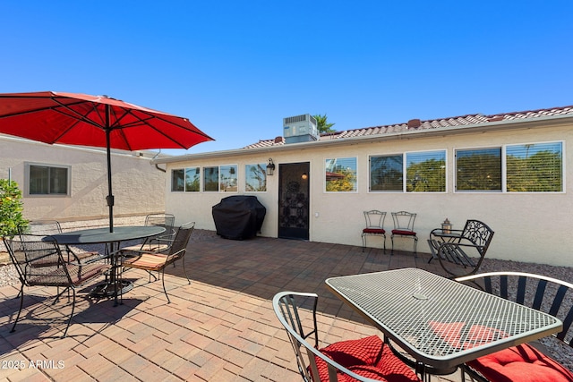 wooden deck with grilling area and a patio area