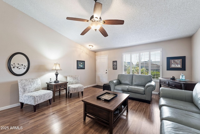 living room with ceiling fan, dark wood-type flooring, a textured ceiling, and vaulted ceiling