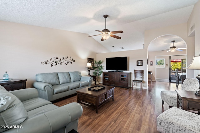 living room featuring dark hardwood / wood-style flooring, a textured ceiling, lofted ceiling, and ceiling fan