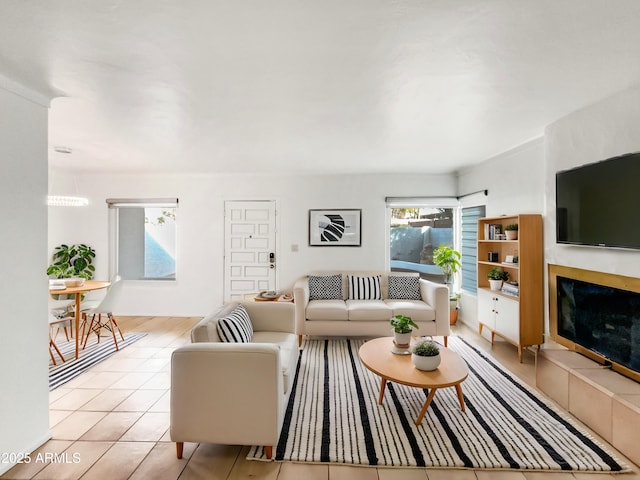 tiled living room featuring a tiled fireplace