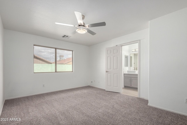 empty room featuring light carpet, baseboards, visible vents, and a ceiling fan