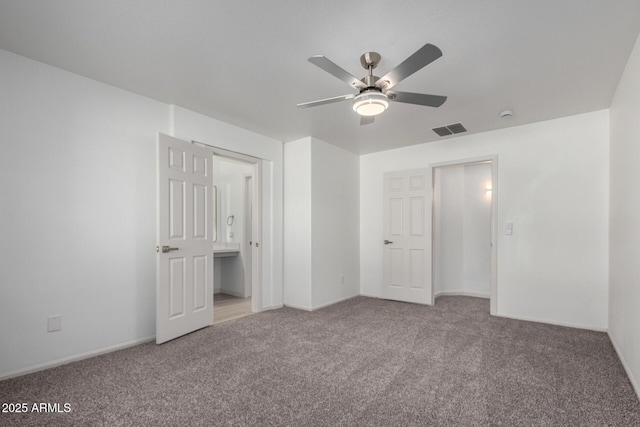 unfurnished bedroom featuring baseboards, visible vents, ceiling fan, and carpet flooring