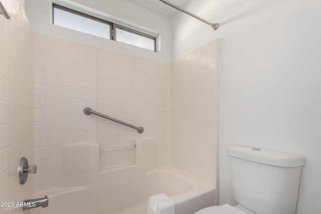 bathroom featuring bathing tub / shower combination and toilet