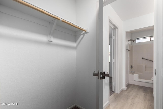 walk in closet featuring light wood finished floors