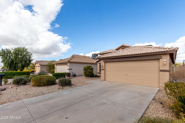 view of front of home featuring a garage, a tile roof, and stucco siding