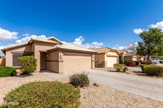 view of front of house featuring a garage, concrete driveway, a tile roof, and stucco siding