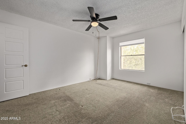 empty room with ceiling fan, carpet floors, and a textured ceiling