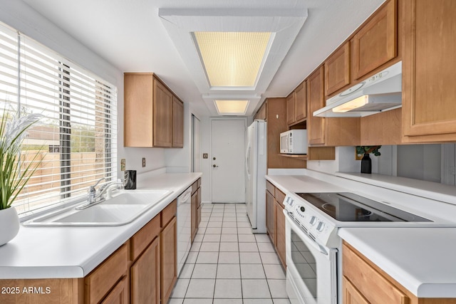 kitchen with sink, light tile patterned floors, and white appliances