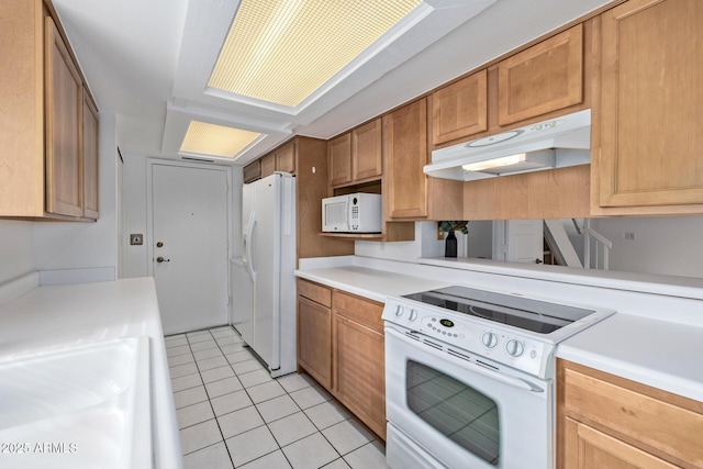 kitchen featuring sink, light tile patterned floors, and white appliances