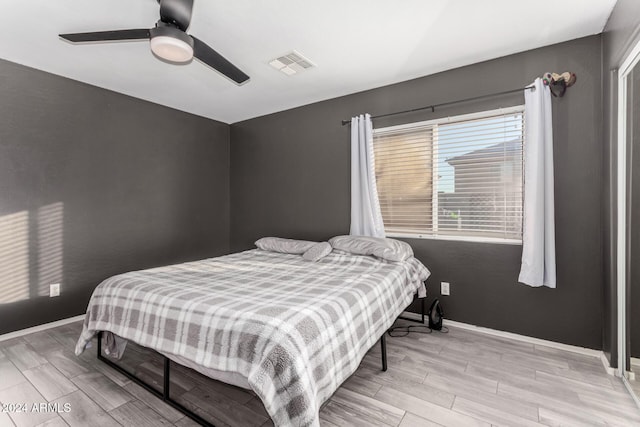 bedroom featuring light wood-type flooring and ceiling fan