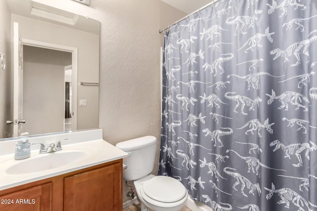 bathroom with vanity, toilet, and walk in shower