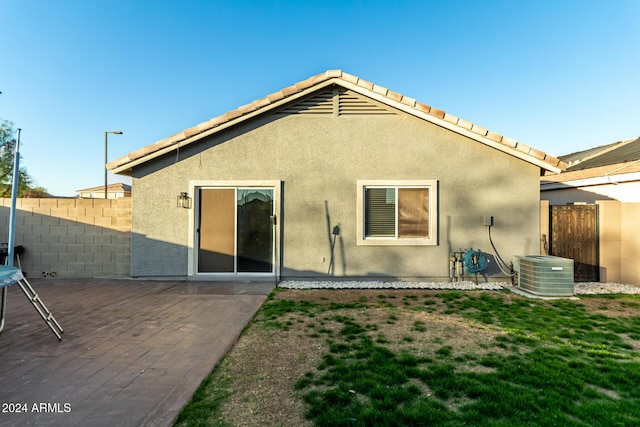 back of property with central AC unit