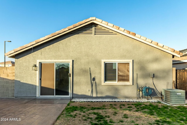 back of house featuring cooling unit