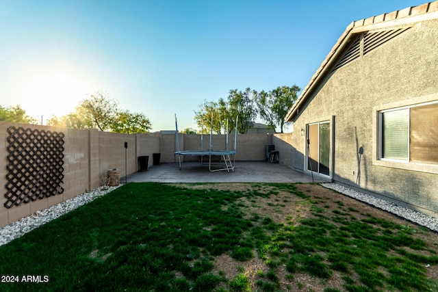 view of yard featuring a patio area and a trampoline